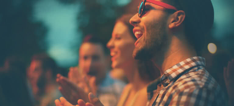 Fans clapping at concert